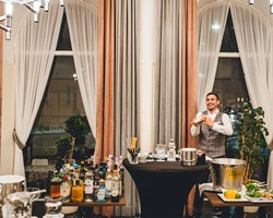 Experience modern mixology Bartender hosting a cocktail class with shaker and bar setup at Veranda Brasserie & Bar.