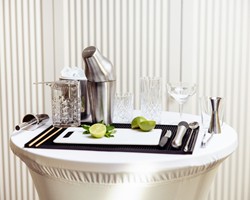 Discover modern mixology Professional bar setup with shaker, glassware and limes for a cocktail class at Veranda Brasserie & Bar.